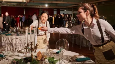 two waitresses lighting candles